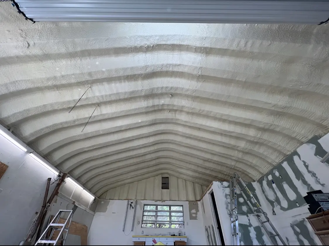 Spray polyurethane foam applied to the underside of a metal roof deck in Hudson